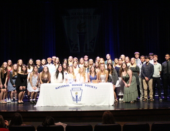 Group photo on stage with the NHS table.
