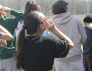 Female student looking up at solar eclipse