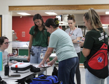 Baker MERT checking a students medical records