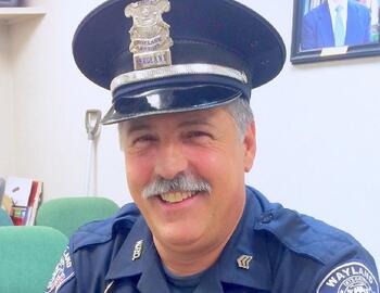 Officer Rookus in his Police Hat Smiling