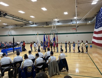 Several students in a line behind the podium, waiting to speak