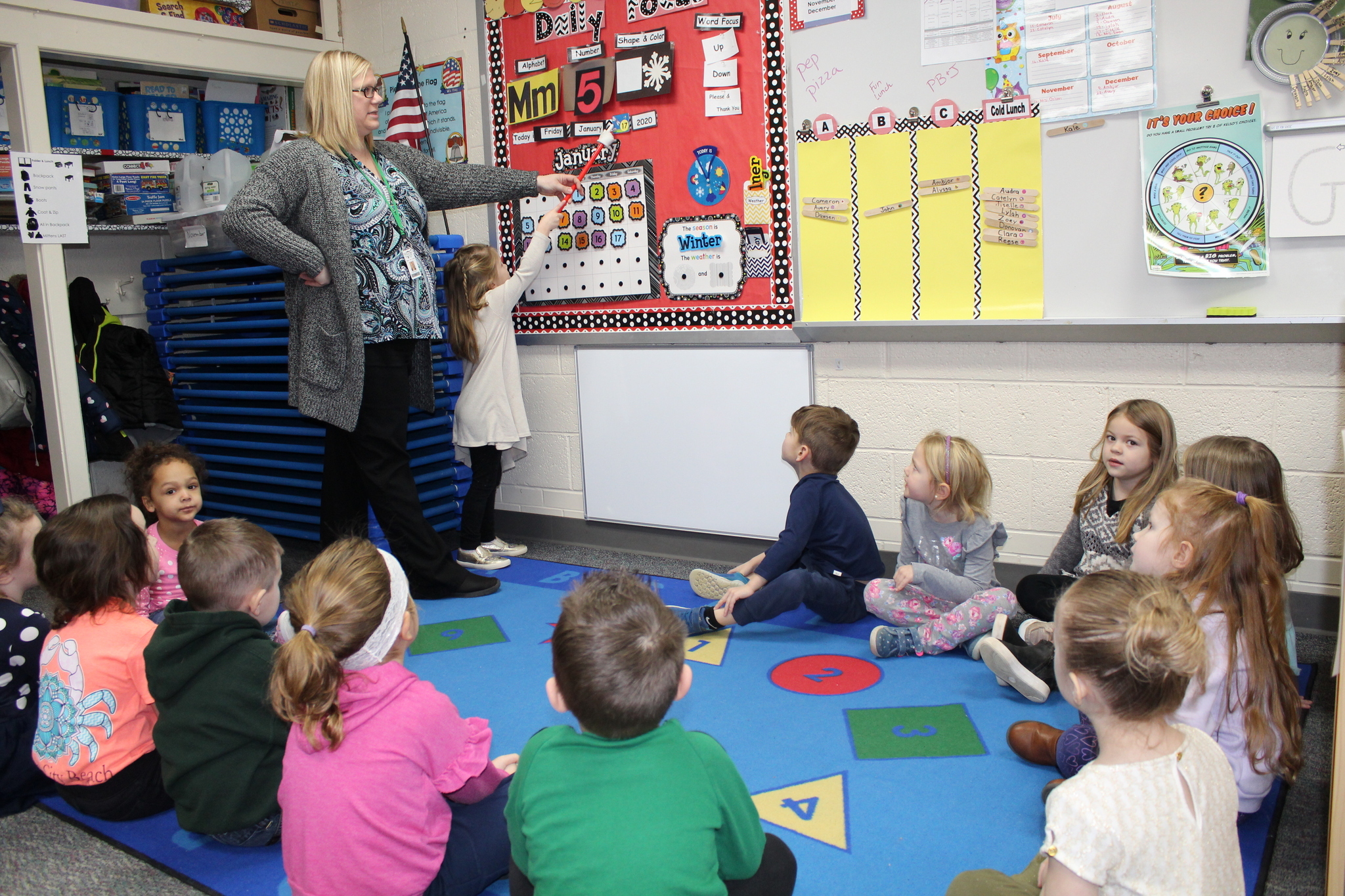 teacher helping children in circle time